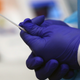 A medical worker holding a swab at ProHEALTH center in Brooklyn in August 2020.
